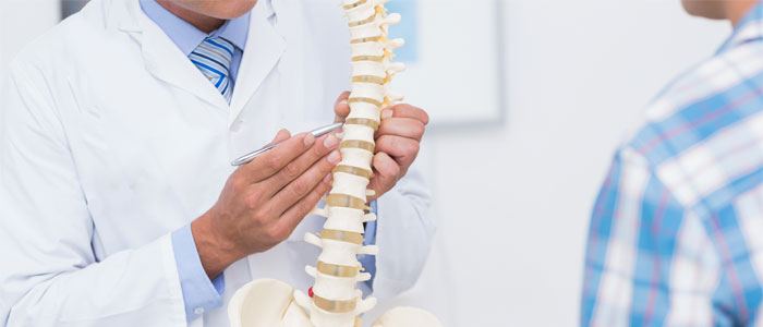 chiropractor explaining a herniated disc to patient